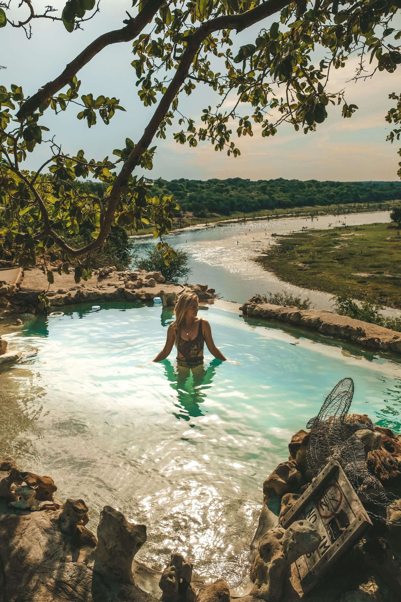 Blonde in pool at Meno a Kwena in Botswana
